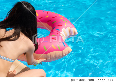 Girl with Inflatable swim ring in shape of donut Girl with Inflatable swim ring in shape of donut 33360745