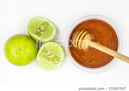 Honey and lemon on white background. Honey and lemon on white background. 33365597