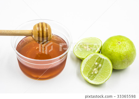 Honey and lemon on white background. Honey and lemon on white background. 33365598