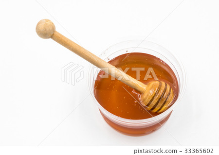 Honey with wood stick on white background. Honey with wood stick on white background. 33365602