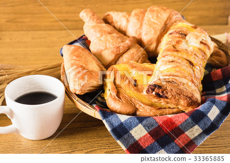 Assortment of pastries with coffee cup on table Assortment of pastries with coffee cup on table 33365885