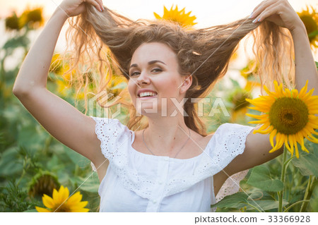 Young woman in a field of sunflowers. sunset light 33366928