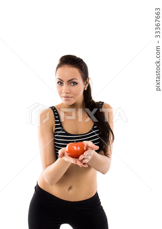 Slim girl wearing training suit offering a tomato Slim girl wearing training suit offering a tomato 33367663