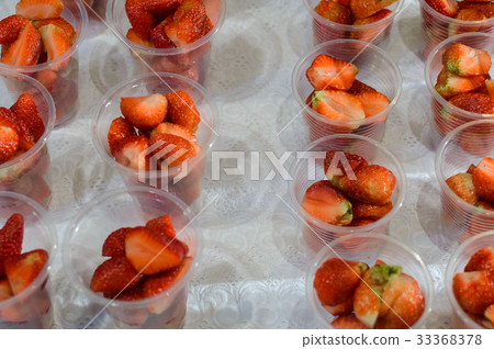 Fresh strawberry in transparent plastic glasses Fresh strawberry in transparent plastic glasses 33368378