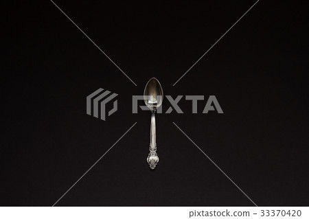 One silver spoon on black background 33370420