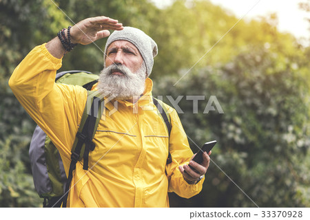 Serious mature male tourist using smartphone 33370928