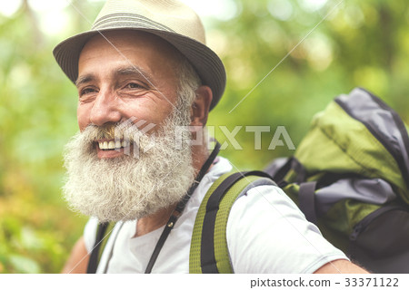 Cheerful old man admiring the nature during hiking Cheerful old man admiring the nature during hiking 33371122