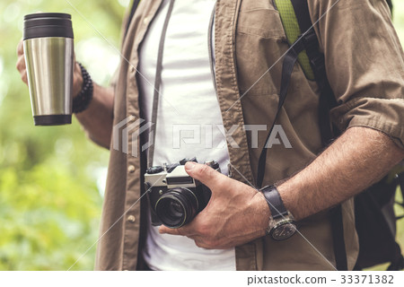 Old male tourist photographing nature while Old male tourist photographing nature while 33371382