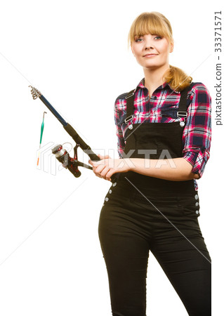 Similing woman wearing check shirt holding fishing rod Similing woman wearing check shirt holding fishing rod 33371571