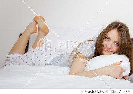 Cheerful girl rolling in bed. Cheerful girl rolling in bed. 33371729