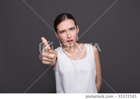 Girl pointing finger and shouting at camera Girl pointing finger and shouting at camera 33372585
