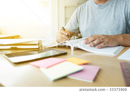 Close up of studying student hands writing in book 33373908