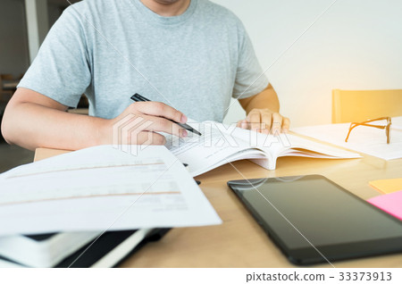 Close up of studying student hands writing in book Close up of studying student hands writing in book 33373913