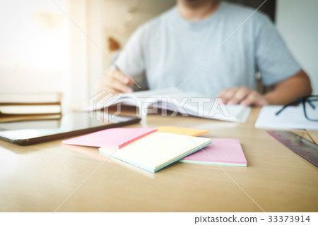 Close up of studying student hands writing in book Close up of studying student hands writing in book 33373914