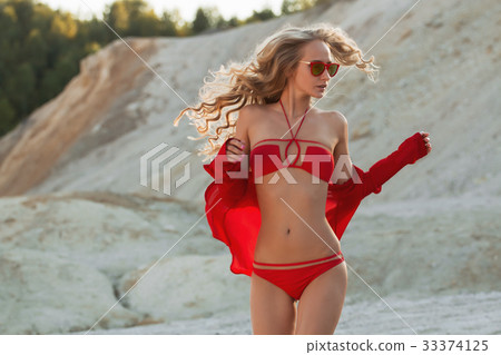 Blonde girl in red swimsuit on the beach Blonde girl in red swimsuit on the beach 33374125