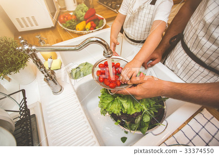 Father with son washes vegetables before eating 33374550