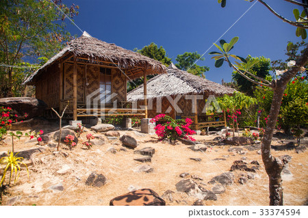 wooden bungalows in tropical garden  33374594