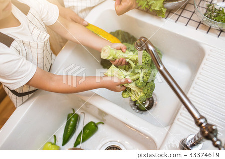 Father with son washes vegetables before eating Father with son washes vegetables before eating 33374619