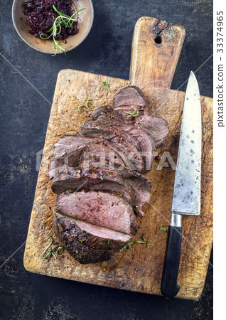 Roast Venison Sliced on Cutting Board 33374965