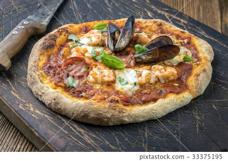 Seafood Pizza on old Cutting Board Seafood Pizza on old Cutting Board 33375195