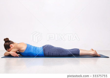 Womand relax in Hatha yoga asana Makarasana 33375755