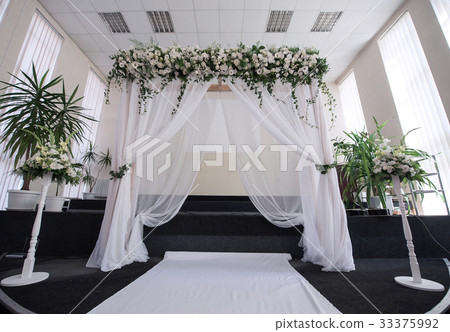 Decorated hall for a wedding ceremony with an arch 33375992