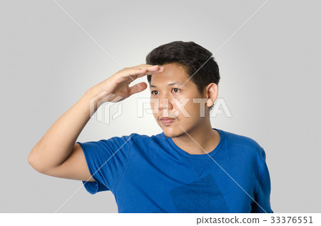 Asian man looking for something isolated on gray Asian man looking for something isolated on gray 33376551