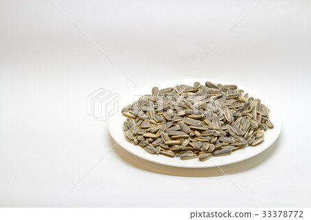 Dried sunflower seeds in white plate  33378772