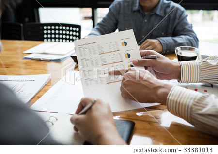 Co-workers are consultants on business documents Co-workers are consultants on business documents 33381013