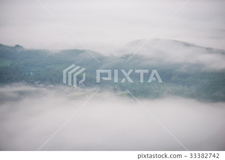 Landscape of misty mountain forest covered hills  33382742