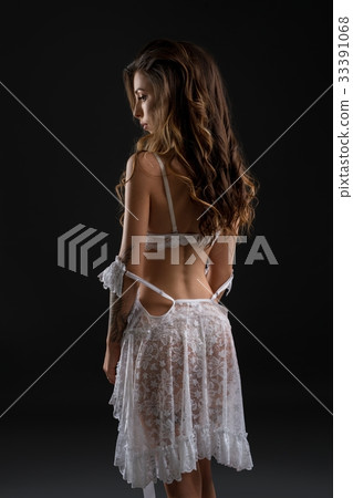 Rearview shot of woman posing in white lingerie Rearview shot of woman posing in white lingerie 33391068