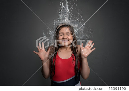 Teenage girl catching water stream from top 33391190