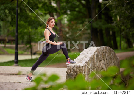 Girl stretching in park 33392815