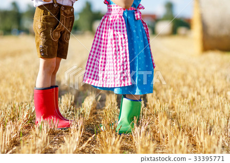 Two kids in traditional Bavarian costumes and red Two kids in traditional Bavarian costumes and red 33395771
