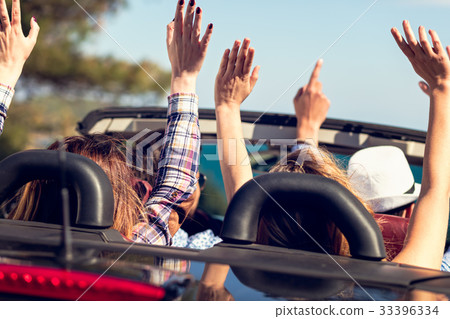 Group of happy young friends in cabriolet with Group of happy young friends in cabriolet with 33396334