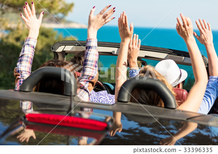 Group of happy young friends in cabriolet with Group of happy young friends in cabriolet with 33396335