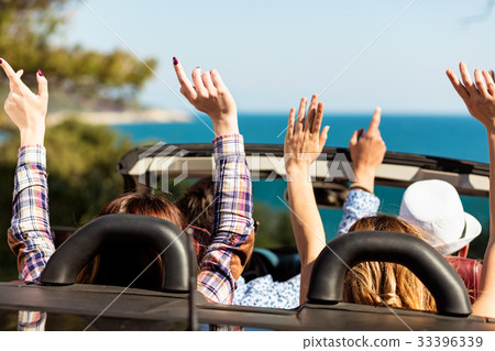 Group of happy young friends in cabriolet with Group of happy young friends in cabriolet with 33396339