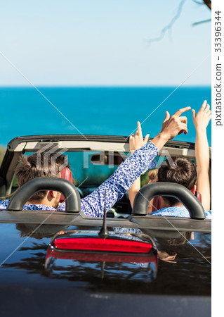 Group of happy young friends in cabriolet with Group of happy young friends in cabriolet with 33396344