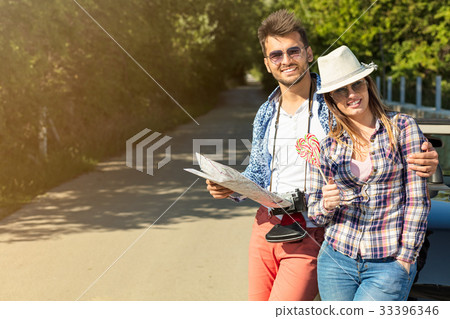 happy friends with map driving in cabriolet car at happy friends with map driving in cabriolet car at 33396346