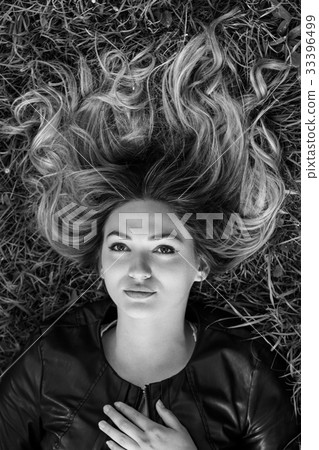 happy young woman laying on the grass in park happy young woman laying on the grass in park 33396499