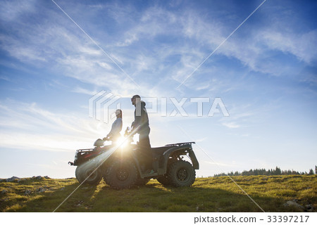 Beautiful couple is watching the sunset from the Beautiful couple is watching the sunset from the 33397217