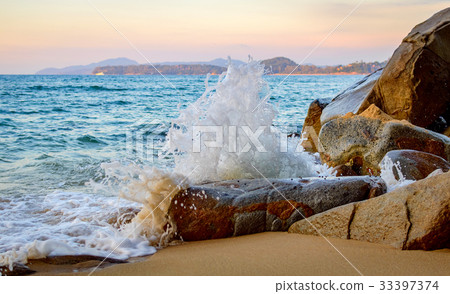 Wave splash in the sea against stone Wave splash in the sea against stone 33397374
