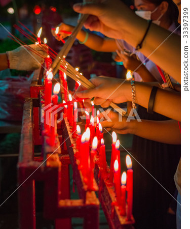 Burning red chinese candle in temple 33397399