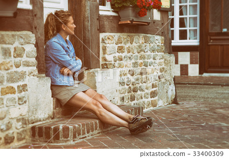Woman sitting at the door Woman sitting at the door 33400309