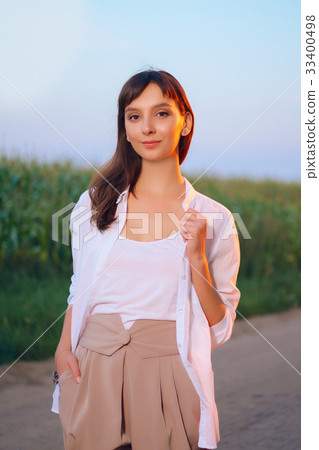Attractive girl in shirt posing on country road Attractive girl in shirt posing on country road 33400498