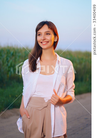Attractive girl in shirt posing on country road 33400499