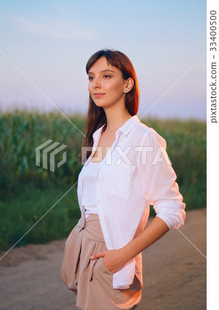 Attractive girl in shirt posing on country road Attractive girl in shirt posing on country road 33400500
