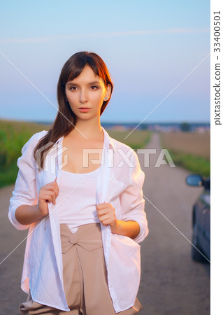 Attractive girl in shirt posing on country road Attractive girl in shirt posing on country road 33400501