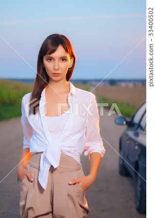 Attractive girl in shirt posing on country road Attractive girl in shirt posing on country road 33400502