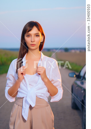 Attractive girl in shirt posing on country road Attractive girl in shirt posing on country road 33400503